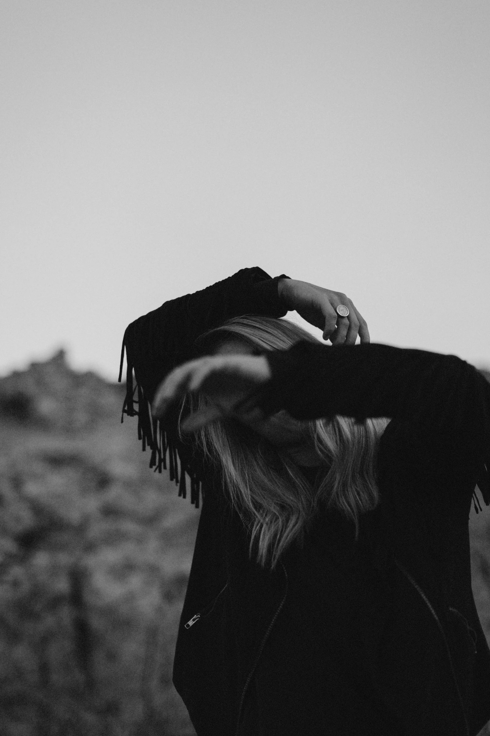 the back of a womans coat in a desert setting