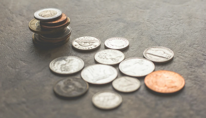 small piles of pennets, one dollar, and one penny