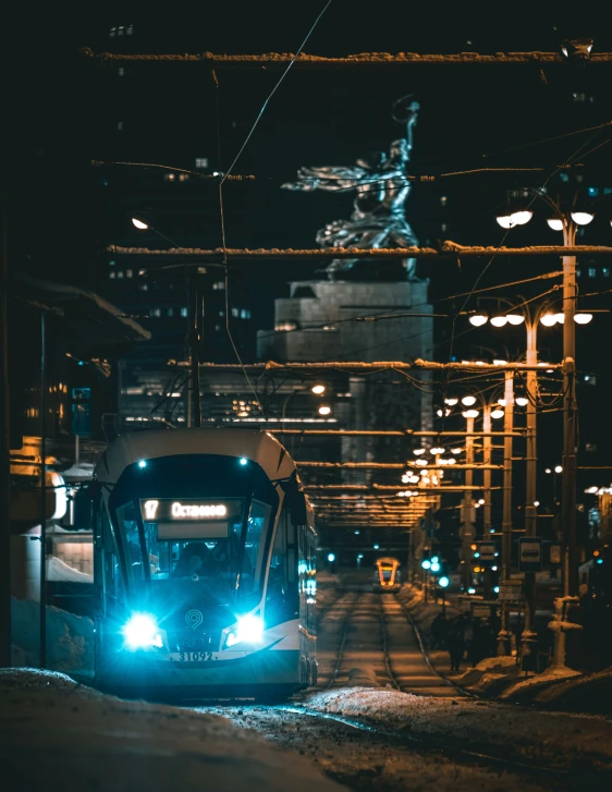 a transit train on a city street at night