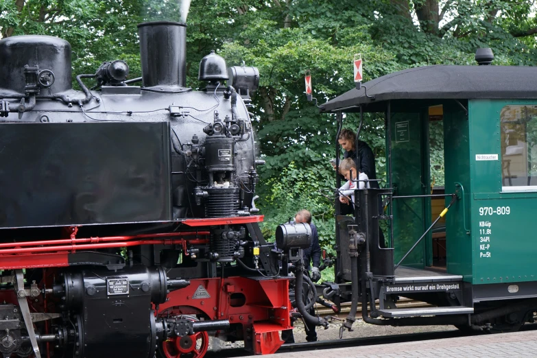 there is a train that has a green caboose