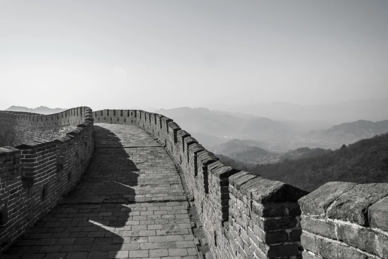 a brick wall is shown with mountains in the background