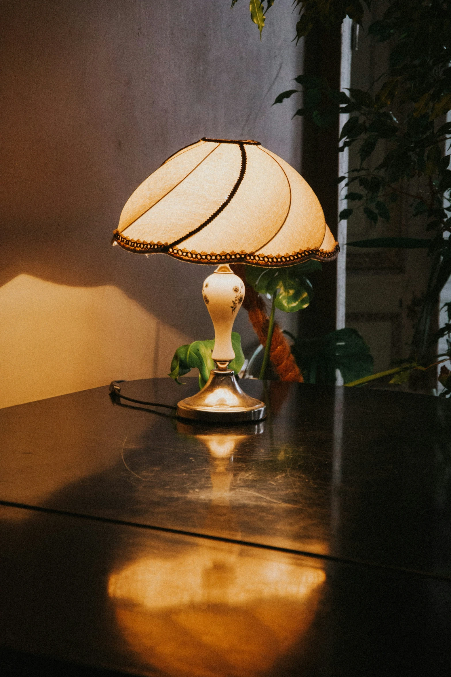 a gold lamp on a wood table