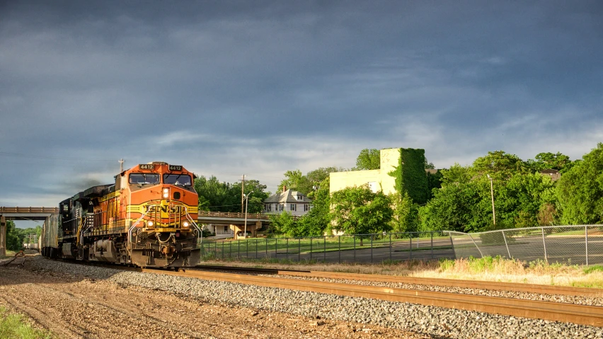 a train passes under a bridge in a city