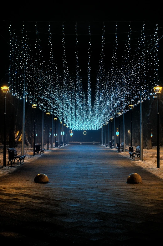 a city street has lights strung down from the ceiling