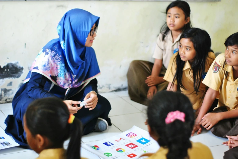 the children are listening to a teacher explain their plans