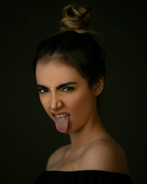 a woman sticking her tongue out while standing