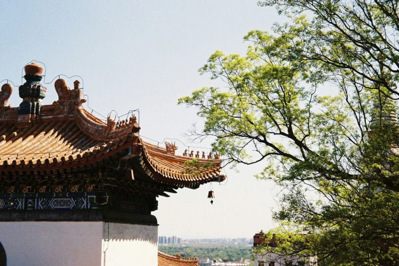 an oriental building sits high up on the side of a hill