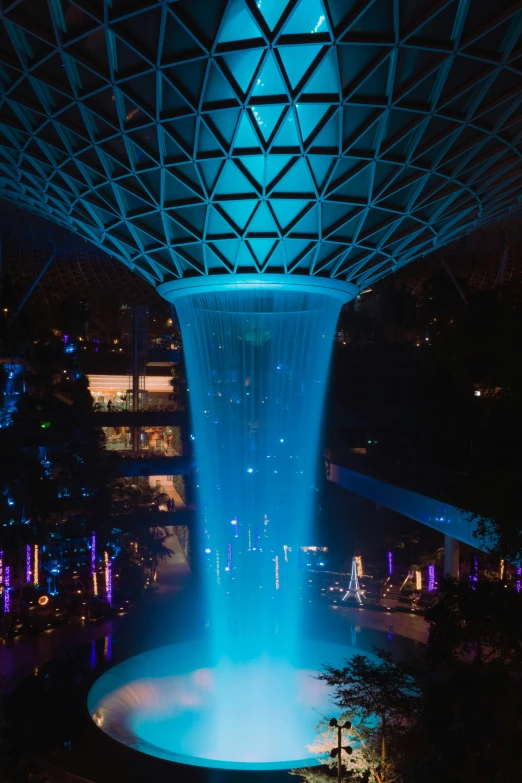 an illuminated fountain lit up in the night
