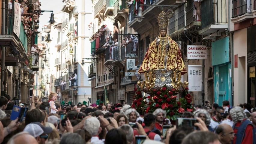 the crowded city street is lined with many people