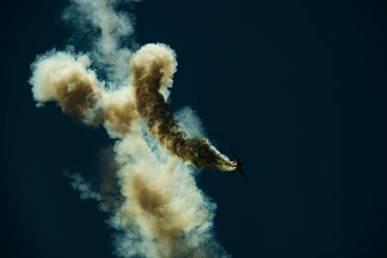 a smoke filled airplane in flight on a sunny day