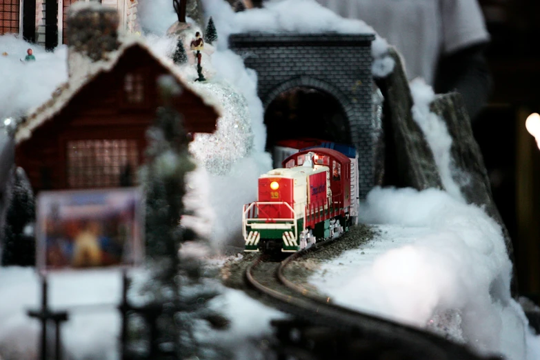 a train drives through a snowy winter scene