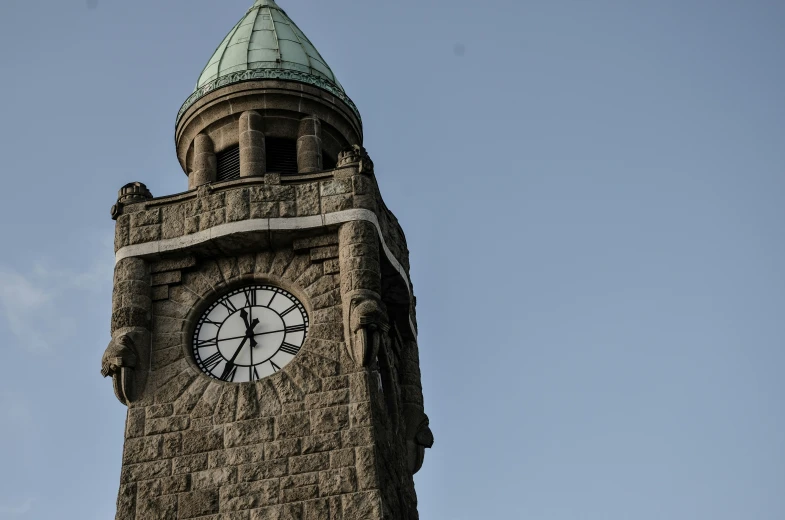 a clock tower with a spire sits on top