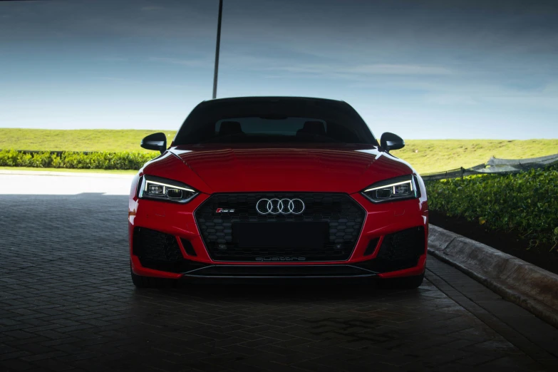 an red car parked in front of a building