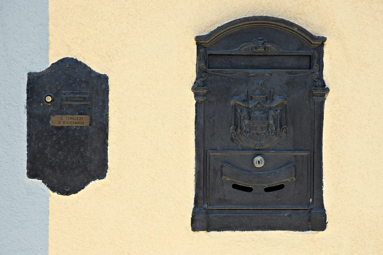 a blue and white wall with some black mailboxs