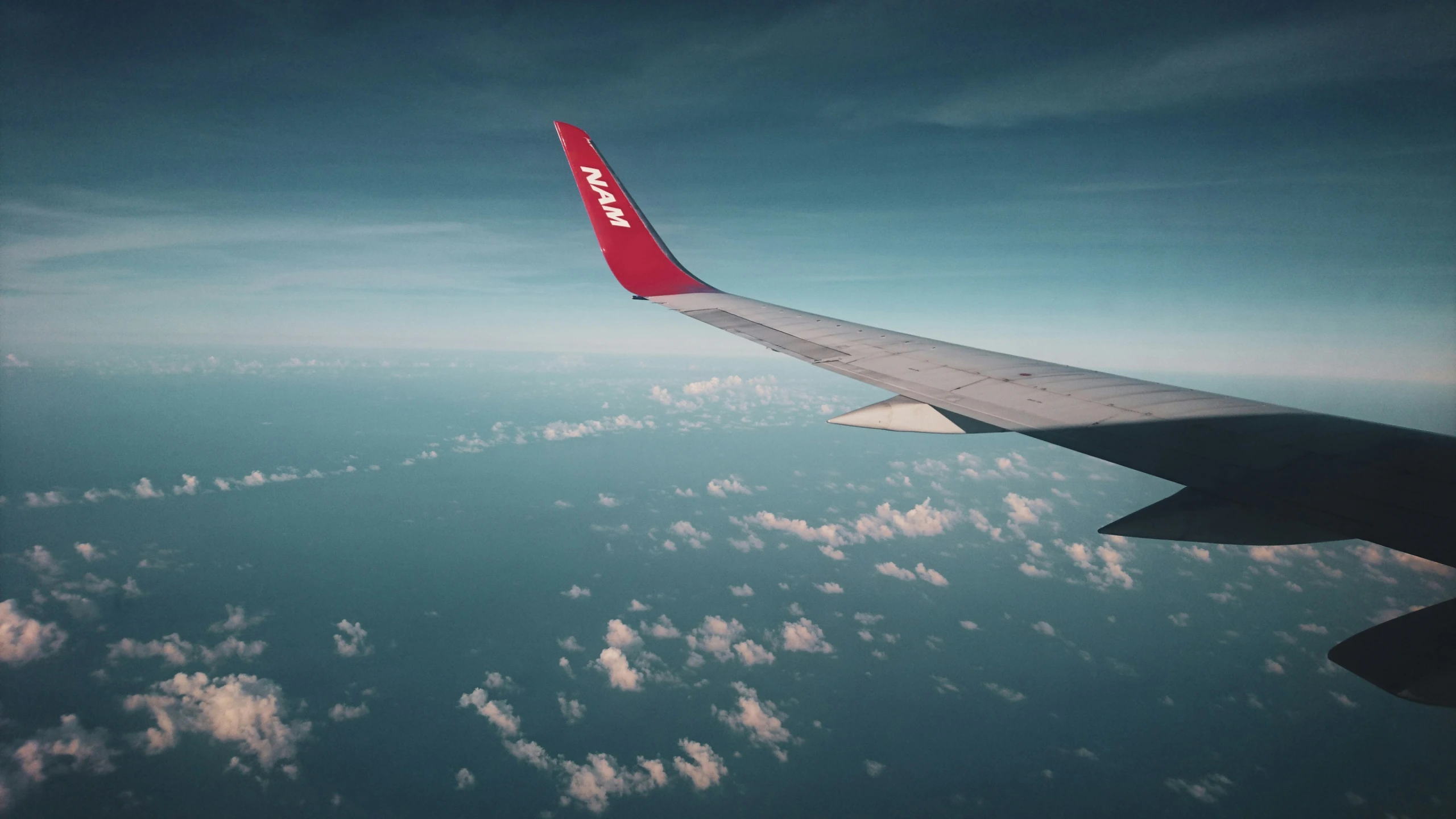 looking through the window seat at a very bright airplane wing