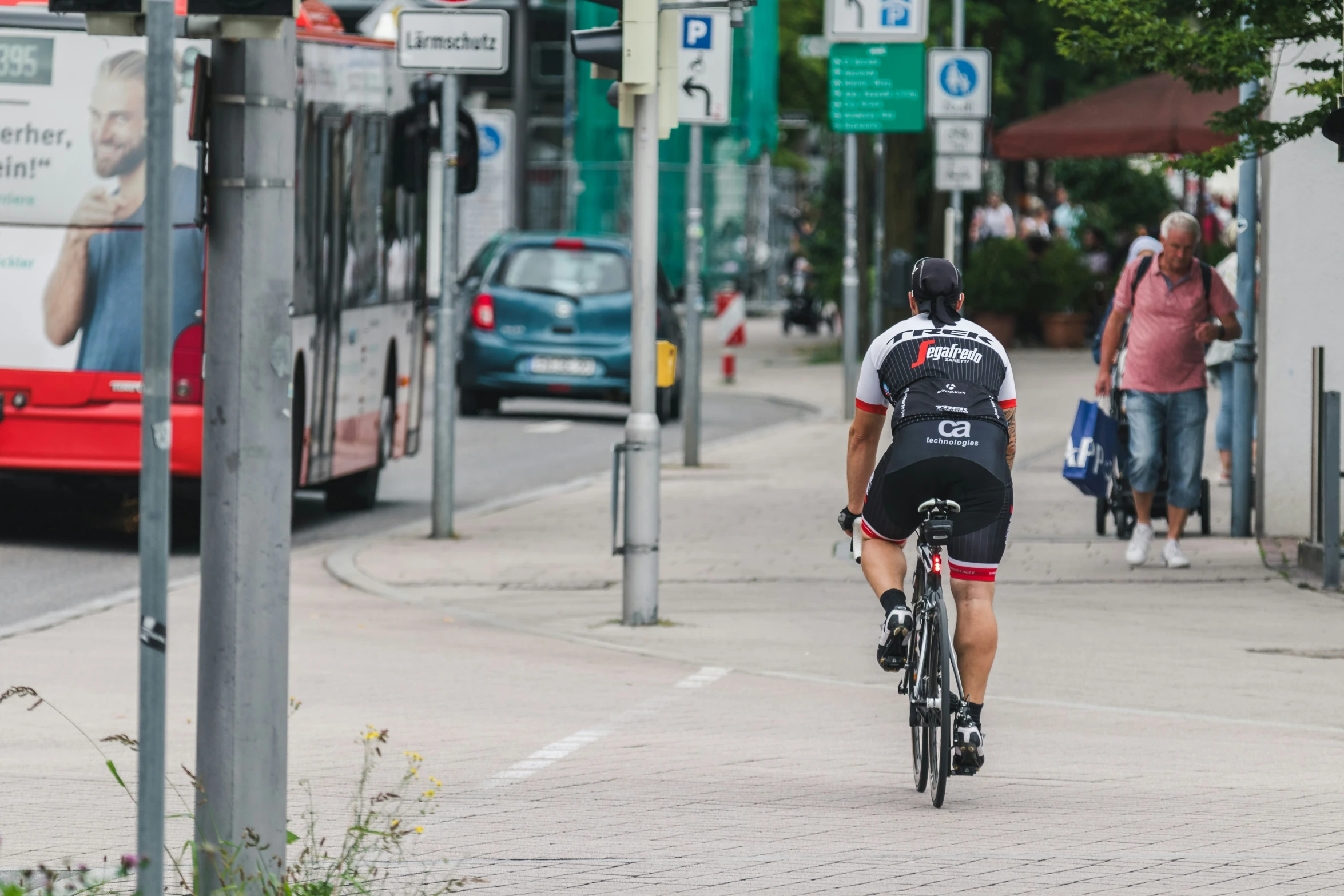 cyclist wearing bike backpack near busy city intersection