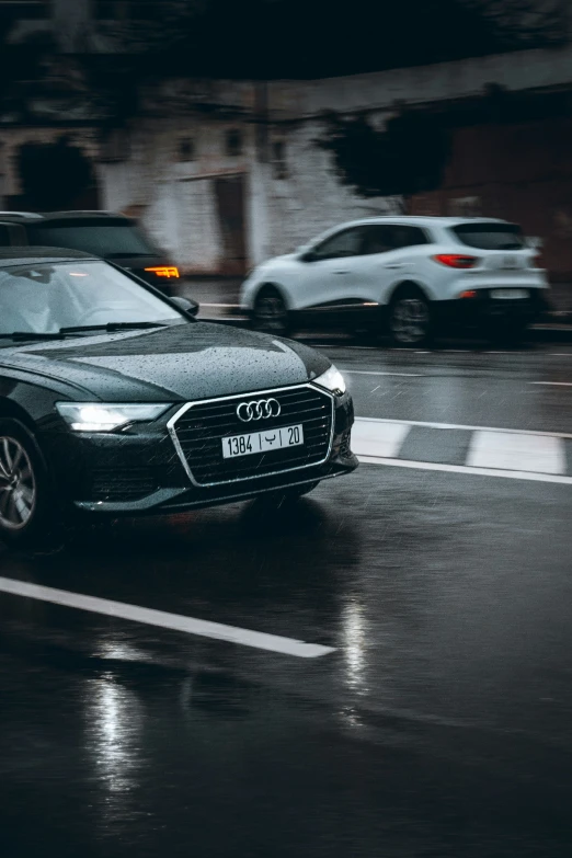 a car drives down the street in the rain