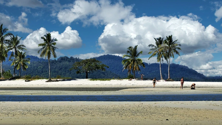 people are standing at the edge of a body of water