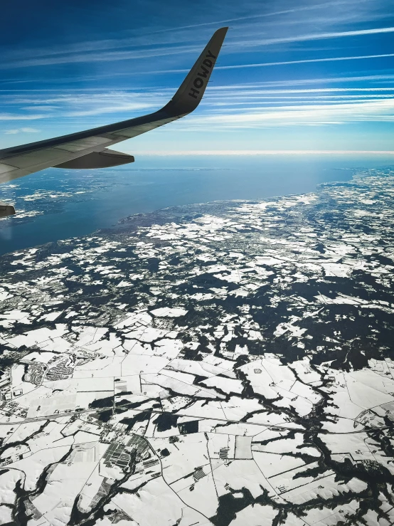 a view from an airplane that has a body of water