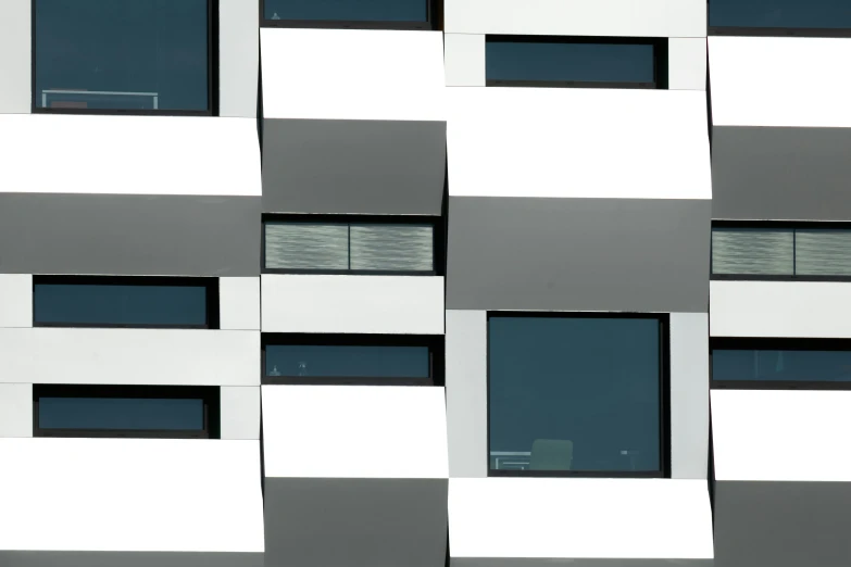 white and grey squares on a large wall with a window