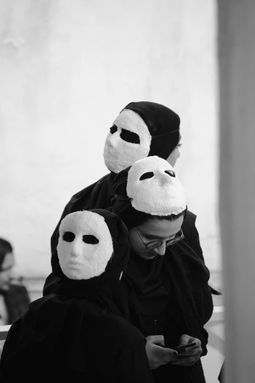 black and white pograph of two people with masks on