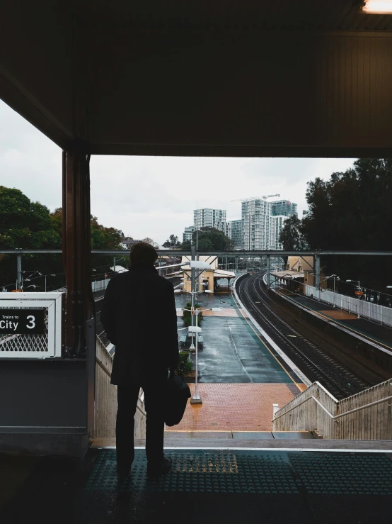 a person walking into an indoor train station