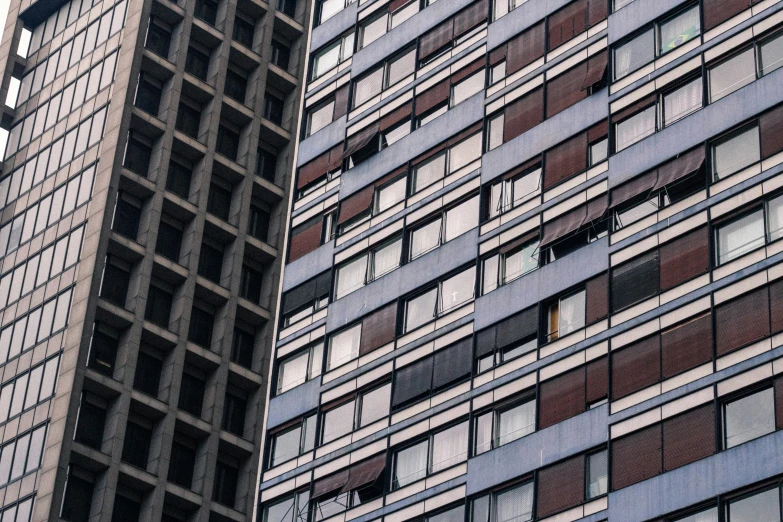 a red and white airplane flying next to tall building