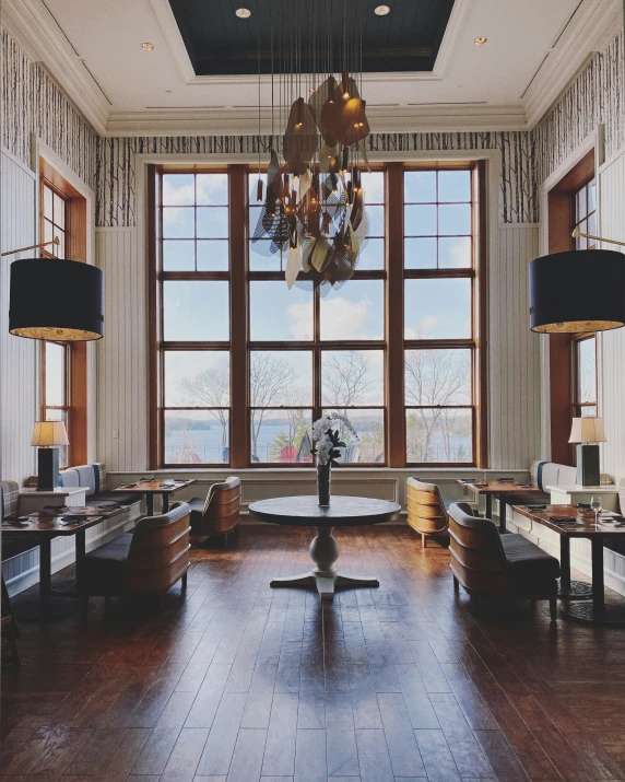 a dining room with wooden floors and tables and chandeliers