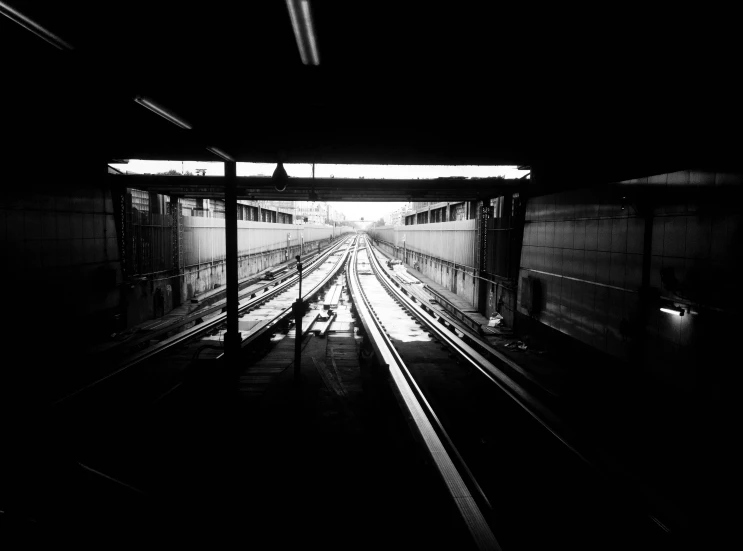 a black and white po of an empty train station