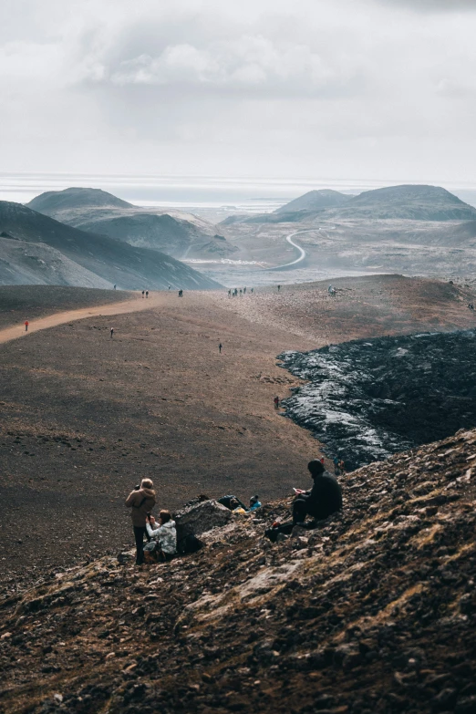 some people are on the side of a hill looking over a valley