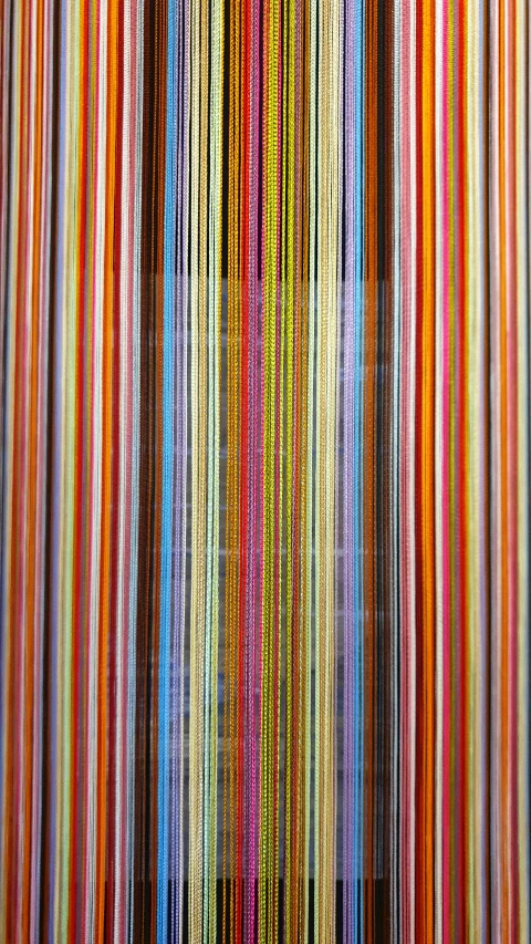 a rainbow of colored lines on a white wall