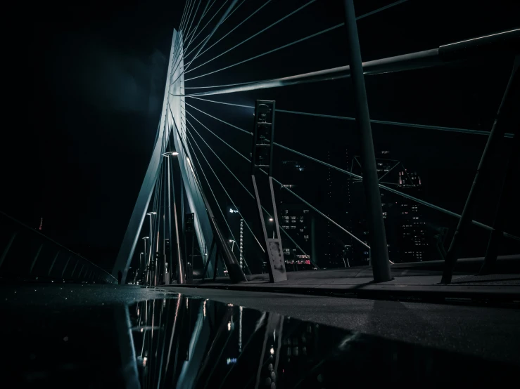 a suspension bridge lit up by street lights