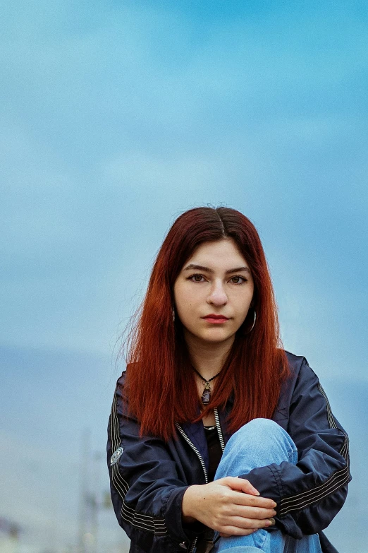 a woman with red hair posing for a po