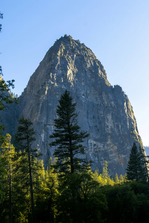 a beautiful mountain with trees around it on a sunny day