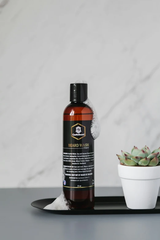 a bottle of aeriumine and a potted plant sit on the counter