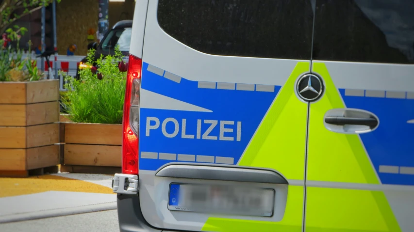 the police car is parked next to some flowers