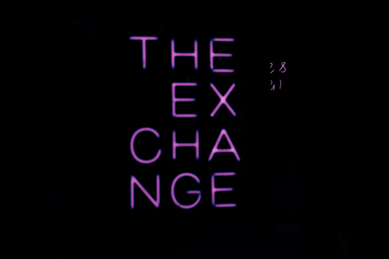 there is a neon sign that reads the ex exchange