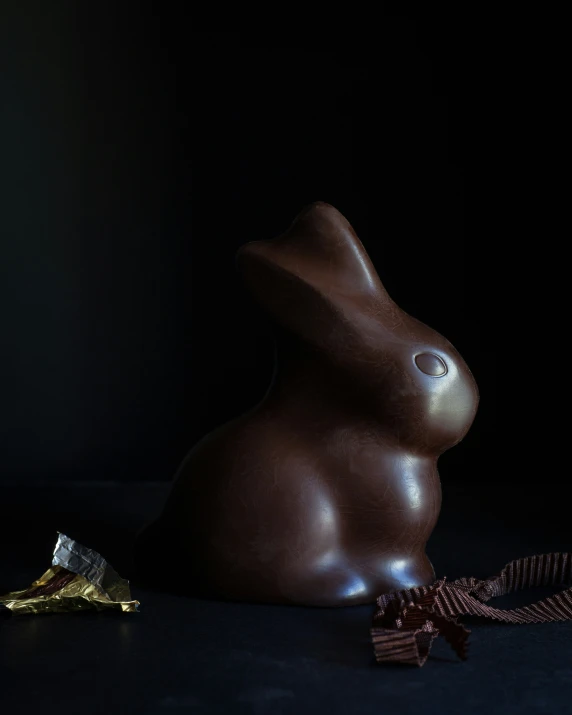 a brown rabbit sitting on the floor with one eye open