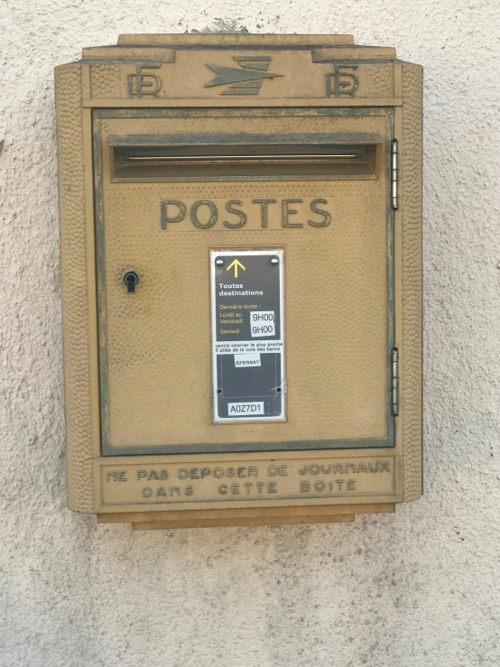 a yellow post box on a wall that says posts