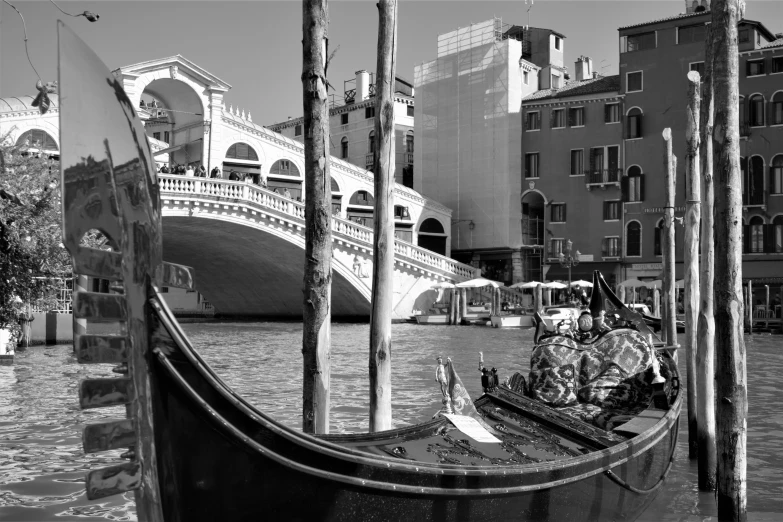 a black and white po of a gondola parked in front of a city street