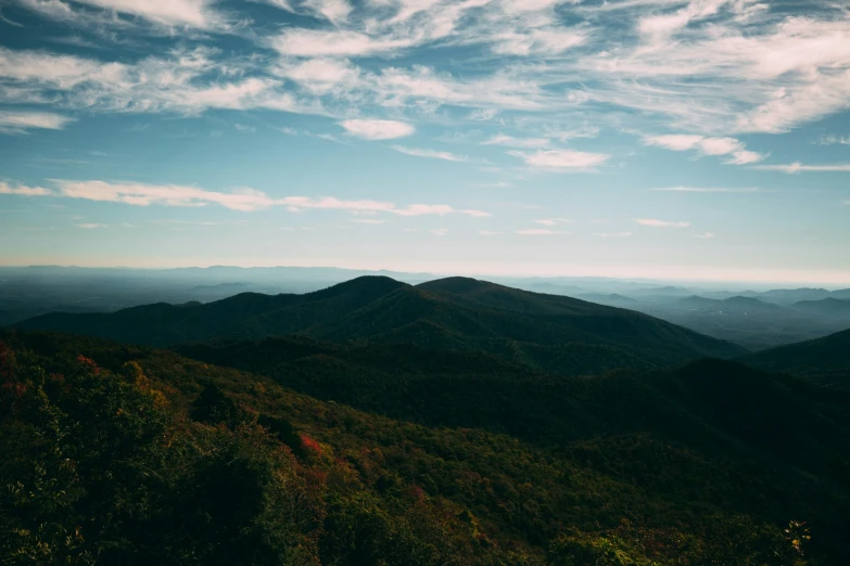 a view of mountains and trees from the top