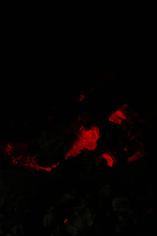 bright red rocks are lit in the dark