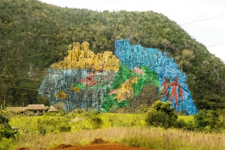 large mural painted on the side of a hillside