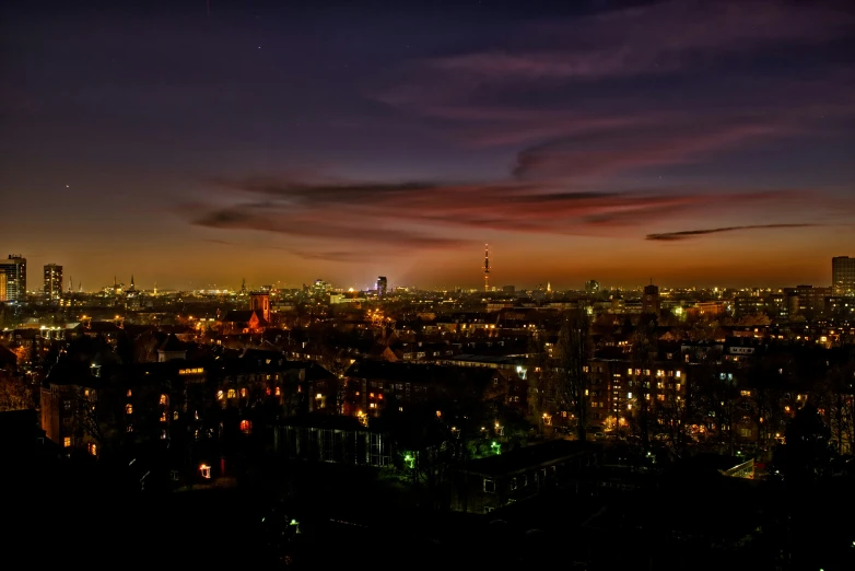 the sky over the city at night time