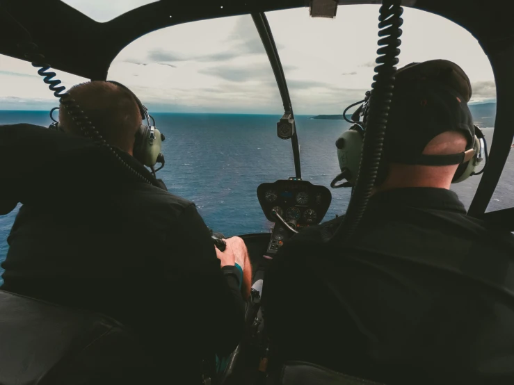 two pilots looking out the cockpit on an aircraft