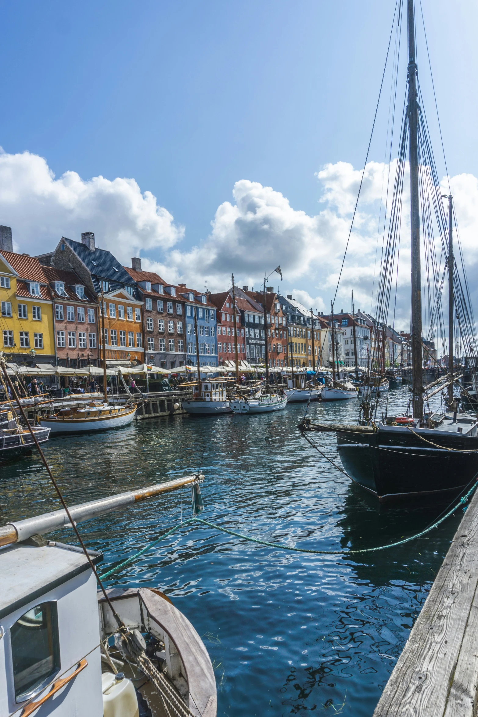 boats are docked on the water next to buildings