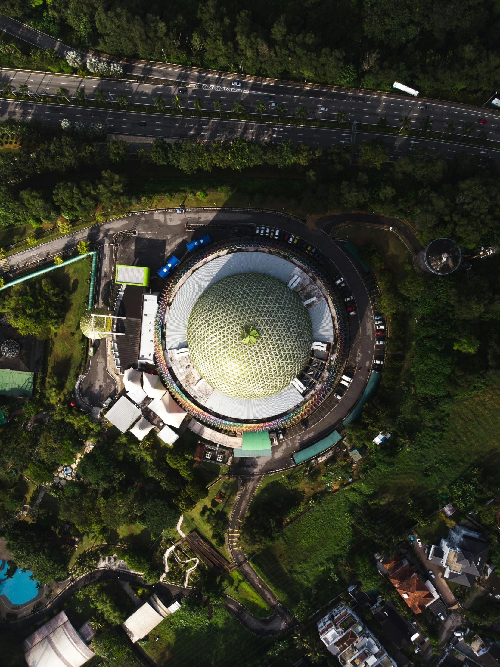 an aerial view of a stadium on a road