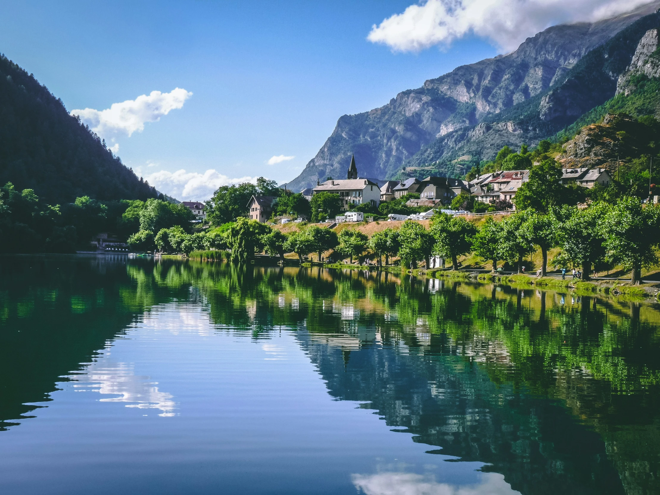 there is a mountain range in the background, and the water is calm