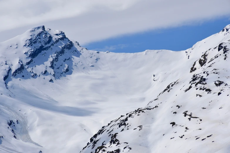 some very big snow covered mountains by a sky