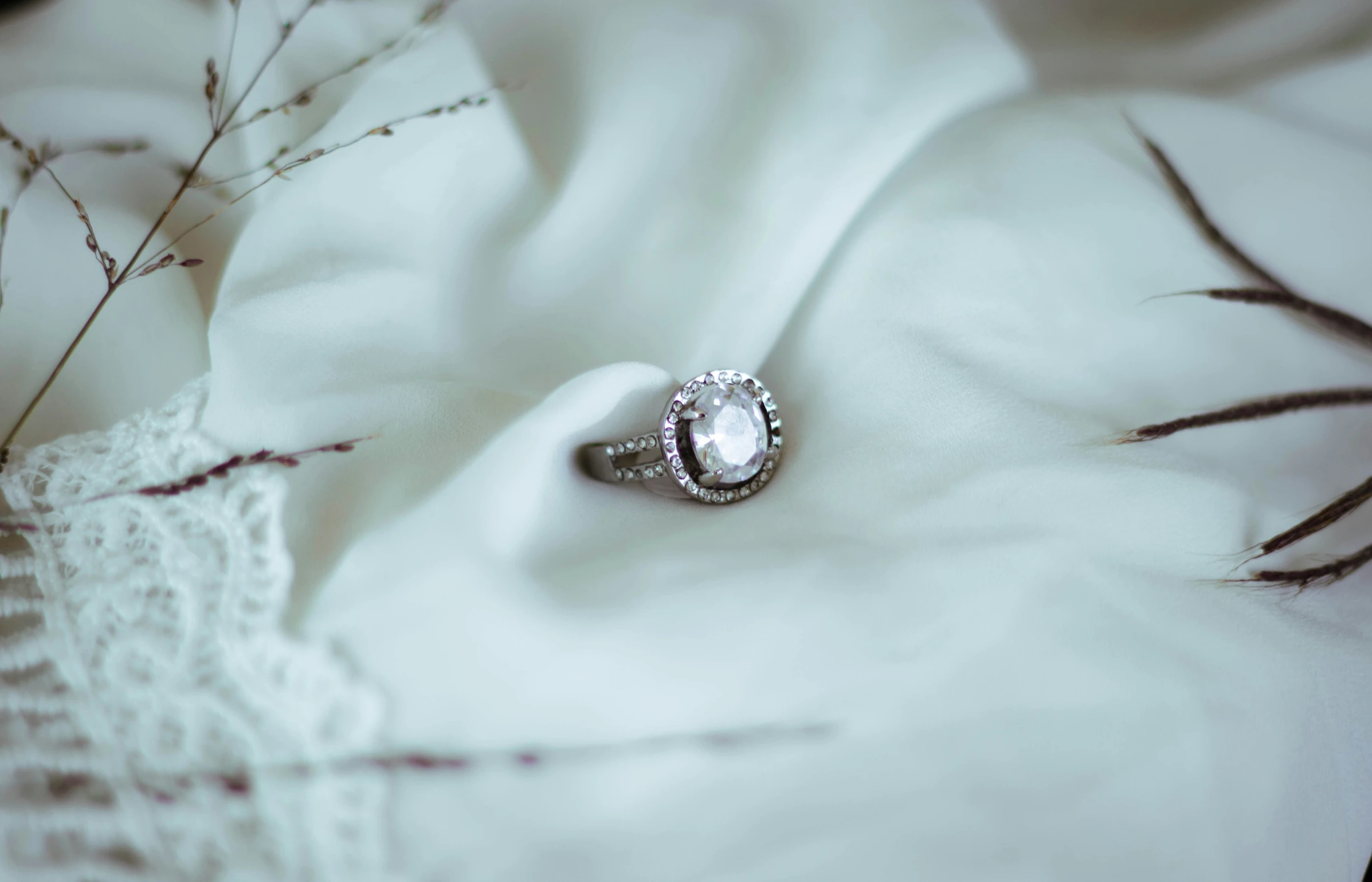 a white wedding ring with small round diamonds on it